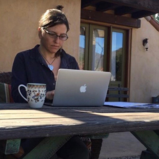 Rebecca typing at her computer